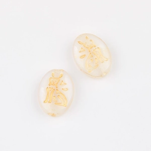 Detail view of two translucent cream Czech glass cat beads with double-sided gold etching