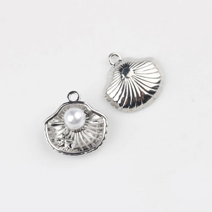 Detailed view of silver shell pendants with pearls and star motifs for jewelry making