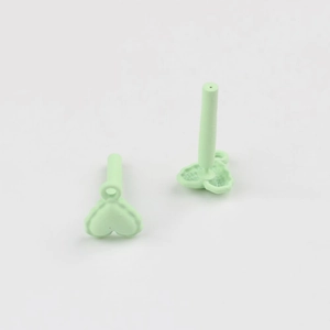 Close-up of mint green matte heart earrings with stainless steel pins and small hanging loop