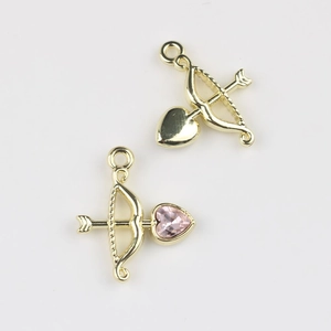Detailed view of cupid arrow pendants with pink heart crystal for DIY jewelry