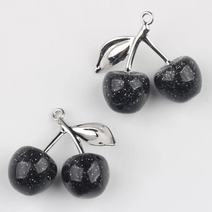 Detail of silver stem cherry charms with black glitter resin for DIY jewelry making