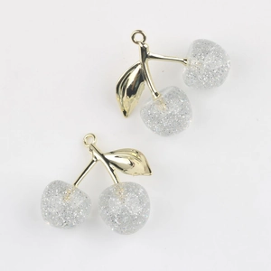 Detail of cherry resin pendants with silver glitter and golden metal leaf for DIY jewelry