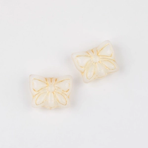 Macro detail of butterfly Czech glass beads with gold gilded edges for DIY jewelry making