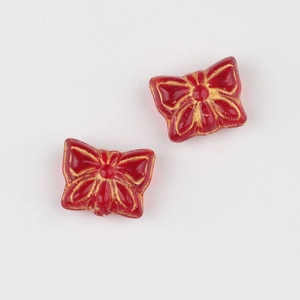 Detail of red butterfly Czech glass beads with gold gilded edges for jewelry making