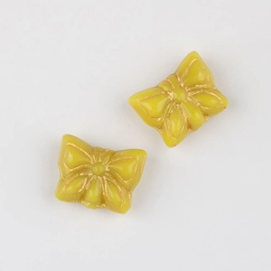 Detail of yellow butterfly Czech glass beads with gold gilded lines for DIY jewelry