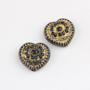 Detail of Czech glass heart beads with gold floral relief and vintage black finish
