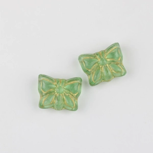 Macro detail of butterfly glass beads with gold-rimmed texture for DIY craft