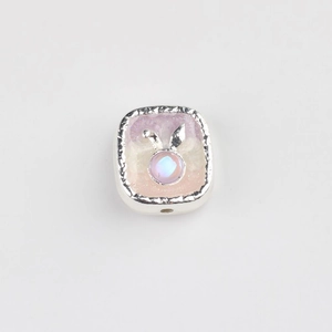 Detailed view of silver square charm with rabbit ears and pink resin inlay for DIY jewelry