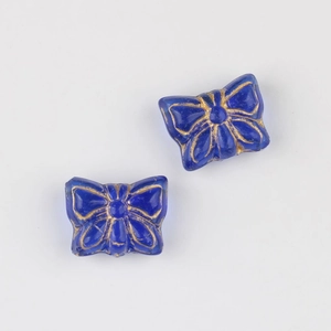 Detail of blue Czech glass butterfly beads with vintage gold gilded outlines for DIY jewelry