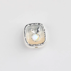 Detail of square alloy bead with bunny ears and opal stone for DIY jewelry making