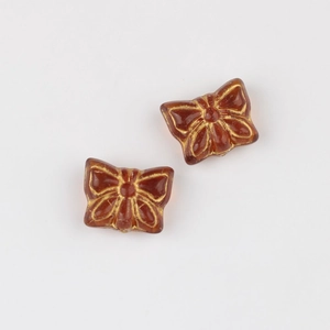 Macro detail of amber butterfly glass beads with gold gilded lines for jewelry DIY