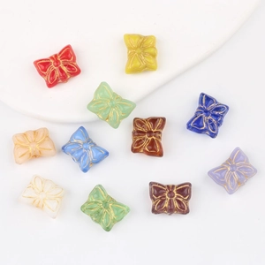 Macro detail of vintage Czech glass butterfly beads with double-sided gold outline finish