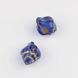 Macro shot of 13mm blue Czech glass conch beads with gold hand-painted spiral texture