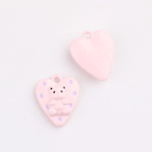 Detailed view of pink heart alloy pendant with 3D bear relief and purple polka dots