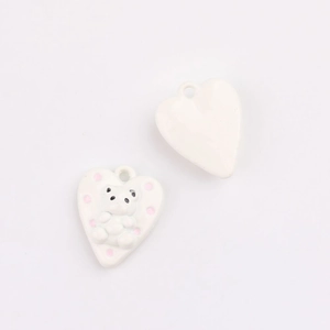 Macro shot of white heart charms with cute 3D bear relief for DIY jewelry accessories