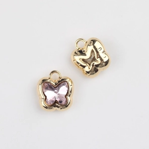 Macro detail of butterfly jewelry charms with pink zircon and 925 hallmarks for DIY