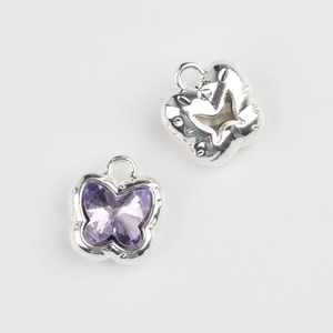 Macro view of butterfly pendant with purple crystal and silver alloy hollow back
