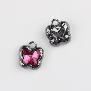 Front and back macro view of butterfly charms with pink crystal and gunmetal finish