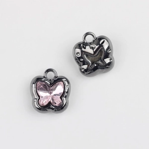 Detail of butterfly pendants with pink zircon stones and gun-black metal plating