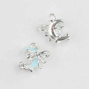 Front and back detail of light blue enamel moon pendants with sparkling crystals