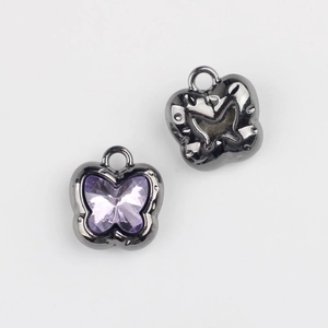 Detail view of butterfly alloy pendant with purple cubic zirconia and dark grey finish