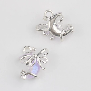 Macro view of moon and bow pendant charm with lavender resin and shimmering zircons