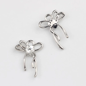 Detailed view showing front and back of silver bow pendant with heart zircon inlay
