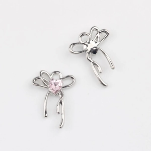 Detailed view of silver bow charm with pink heart zirconia for DIY jewelry making