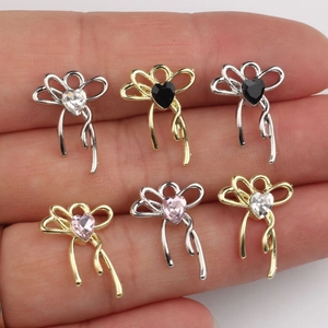 Set of 6 bow-shaped alloy pendants with heart-shaped cubic zirconia and tassels
