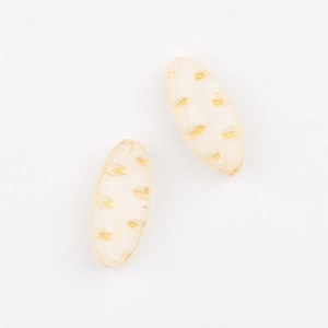 Detailed view of cream-colored Czech glass beads with golden leaf textures for DIY jewelry