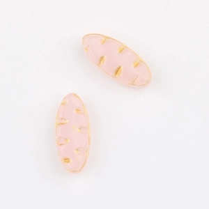 Detail of pink leaf-shaped Czech glass beads with gold accents for DIY jewelry making