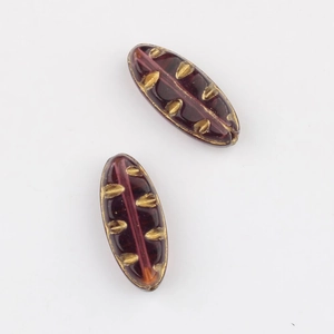 Macro detail of purple Czech glass willow leaf beads with gold foil trim for DIY jewelry
