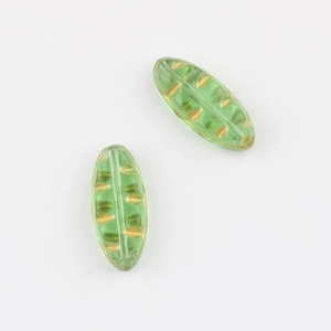 Detail of Czech glass leaf beads in green with gold foil accents for jewelry making