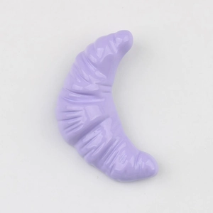 Détail d'un pendentif croissant en résine violet clair avec texture de cuisson