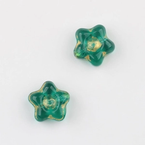 Detail view of translucent green star beads with gold foil finish for DIY jewelry