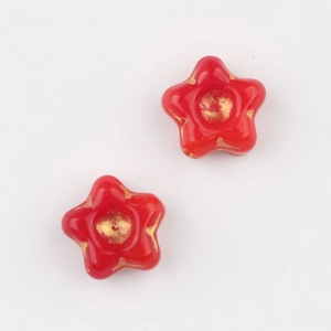 Detail of red flower glass beads with golden glaze finish for jewelry making