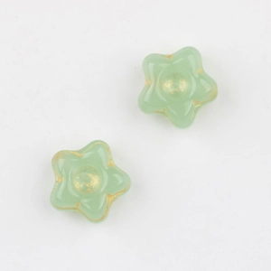 Detail of Czech glass star beads with gold-gilded edges for DIY jewelry making