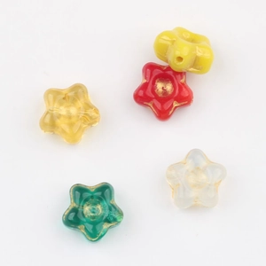 Close-up of star-shaped Czech glass beads with gold gilded edges for DIY jewelry making