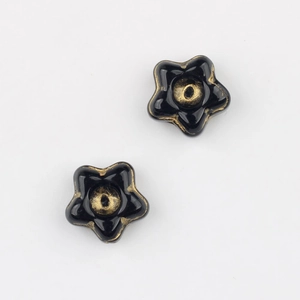 Detailed view of black flower Czech glass beads with gold gilding for DIY jewelry making