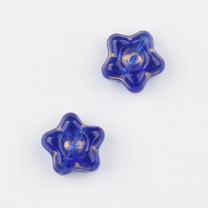 Detail of blue Czech glass star beads with gold gilded accents for DIY jewelry making