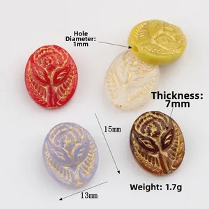 Five vintage embossed rose glass beads in various colors with gold-painted edges for DIY jewelry