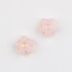 Detail of star-shaped Czech glass beads with hand-painted gold edges in soft pink