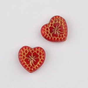 Detailed view of red heart Czech beads with gold vintage patterns for DIY jewelry making