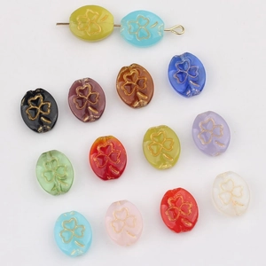 Macro view of multi-color clover glass beads with golden texture for DIY jewelry