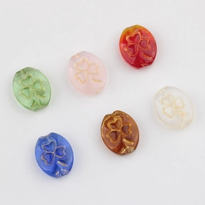 Czech glass beads set with gold clover engraving in various translucent colors