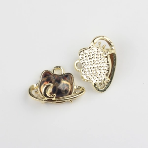 Close-up of cat-shaped alloy pendants with leopard resin and crescent moon detail