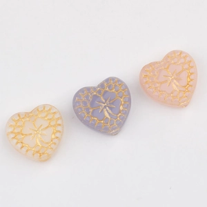 Handmade heart beads with gold floral engraving in white, lilac, and soft pink colors