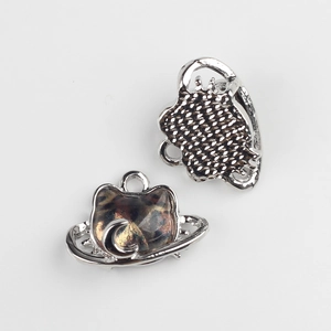Detailed view of silver cat pendant with resin inlay and textured metallic back