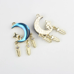 Detailed view of moon and star alloy charms with feathers and purple gradient finish