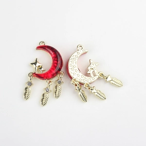 Detailed alloy moon pendant with red enamel, gold texture, and sparkling feather tassels